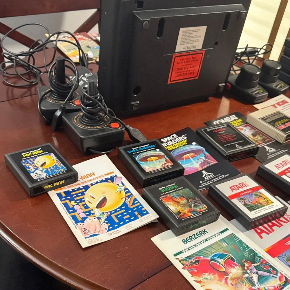 Vintage Authentic Atari 2600 with controllers, games and instruction booklets.